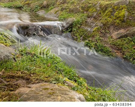 Long exposure of running water in nature Long exposure of running water in nature 63438394