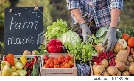 Farmer lays vegetables on the counter 63439060