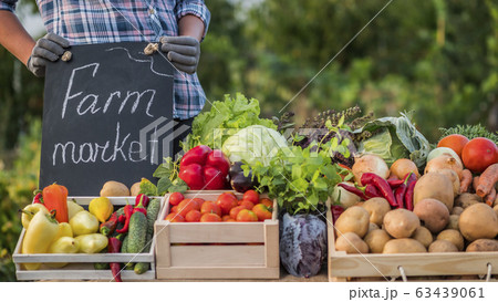 Farmer at the counter where he sells his vegetables 63439061