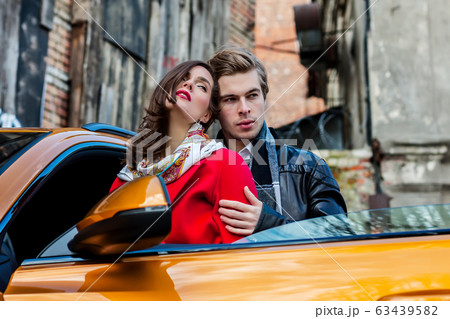 Romantic couple is standing near modern car on the 63439582