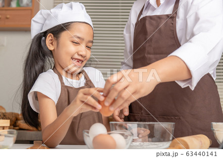 Mother and daughter are helping to collect eggs Mother and daughter are helping to collect eggs 63440141