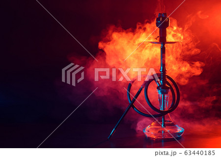 hookah shisha with glass flask and metal bowl with colored smoke on a black background hookah shisha with glass flask and metal bowl with colored smoke on a black background 63440185