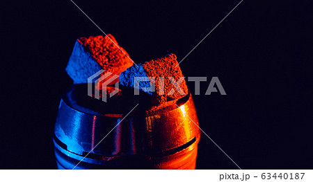 hot red coals for hookah shisha in a metal bowl with red blue neon lighting hot red coals for hookah shisha in a metal bowl with red blue neon lighting 63440187