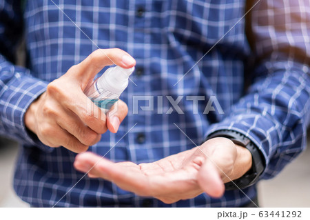 man hand spraying hand alcohol sanitizer bottle man hand spraying hand alcohol sanitizer bottle 63441292