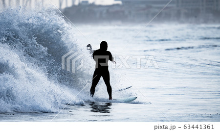 Surfing in front of the breaking wave Surfing in front of the breaking wave 63441361