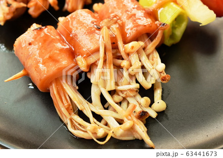 grilled pork bacon rolling needles mushroom with barbecue sauce on plate 63441673