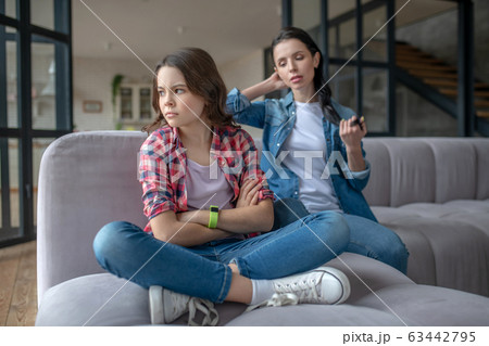 Girl in a checkered shirt looking agressive Girl in a checkered shirt looking agressive 63442795