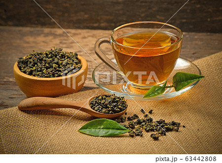 A cup of tea and tea leaf on a background 63442808