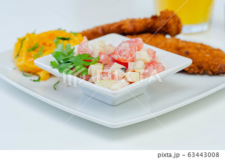 Breaded and herbed chicken breast fillet served Breaded and herbed chicken breast fillet served 63443008