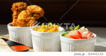 Breaded and herbed chicken breast fillet served 63443133