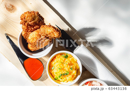 Breaded and herbed chicken breast fillet served 63443136