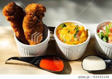 Breaded and herbed chicken breast fillet served 63443140