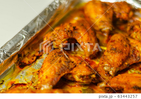 Roasted chicken wings marinated in a spicy Roasted chicken wings marinated in a spicy 63443257