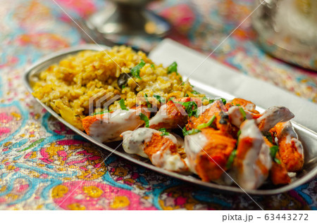 Pieces of cooked marinated chicken breast in an 63443272