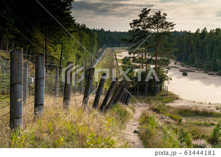 Russia. Saint-Petersburg. Fences of rows of barbed wire , going into the distance, on the shore of the Gulf of Finland at the Fort Krasnaya Gorka  63444181