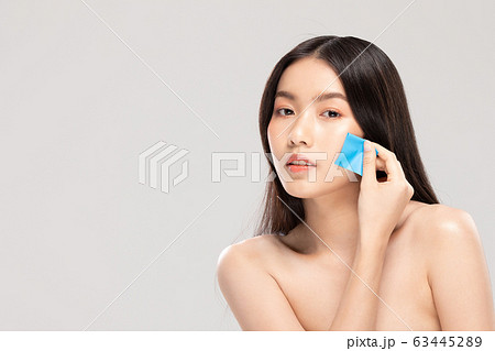 Beautiful Asian young woman touching soft cheek smile with clean fresh skin 63445289