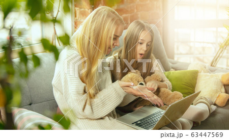 Happy loving family, mother and daughter spending time together at home Happy loving family, mother and daughter spending time together at home 63447569