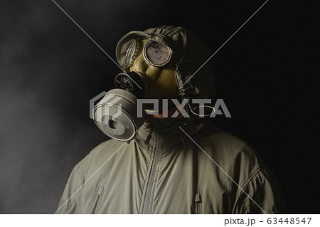 man in a gas mask protects himself from coronavirus 63448547