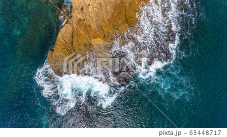 Waves of turquoise water washed by the rocky stone coast of Portugal. Aerial view. Waves of turquoise water washed by the rocky stone coast of Portugal. Aerial view. 63448717