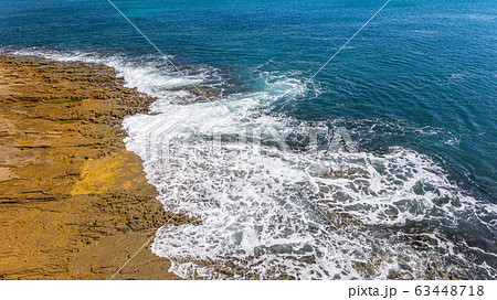 Waves of turquoise water washed by the rocky stone coast of Portugal. Aerial view. 63448718