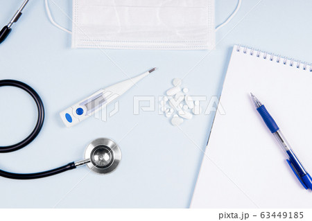 Flatlay doctor workplace with stethoscope and with mask and with notepad mock up. Flatlay doctor workplace with stethoscope and with mask and with notepad mock up. 63449185