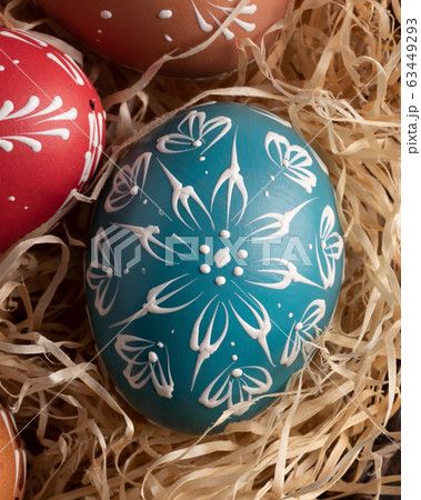 Detail of blue Easter egg decorated with wax 63449293