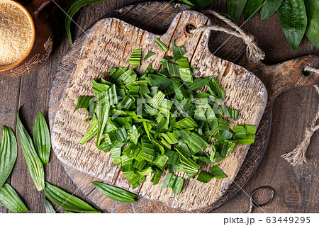 Cut-up fresh plantain leaves - preparation of a homemade herbal syrup 63449295