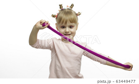 Kid playing with hand made toy slime. Child having fun making purple slime Kid playing with hand made toy slime. Child having fun making purple slime 63449477