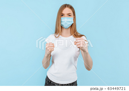 woman in a protective medical mask on her face woman in a protective medical mask on her face 63449721