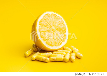 Vitamin capsules. Vitamin C pills and yellow Vitamin capsules. Vitamin C pills and yellow 63449877
