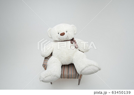 White teddy bear in chair. Isolated on white background 63450139