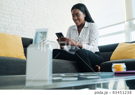 Black Woman Using Portable Wi-Fi Printer For Printing Pictures Black Woman Using Portable Wi-Fi Printer For Printing Pictures 63451238