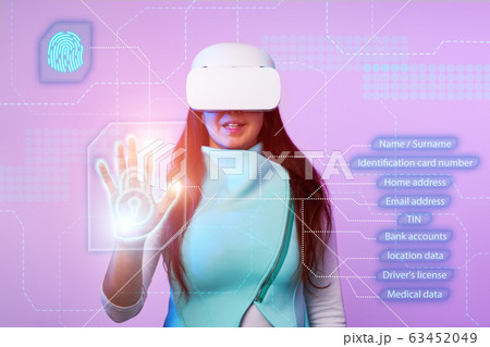 Woman is using vr headset to access for personal data. Woman is using vr headset to access for personal data. 63452049