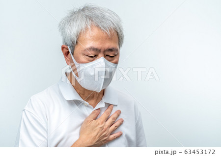 Old Asian man wearing N95 mask, putting his hand Old Asian man wearing N95 mask, putting his hand 63453172