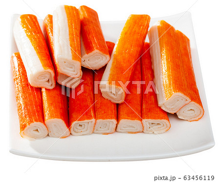 Many crab sticks on white surface 63456119