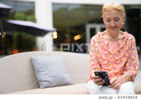 Beautiful senior tourist woman with blond hair relaxing around t Beautiful senior tourist woman with blond hair relaxing around t 63458958