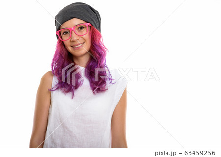 Studio shot of young happy woman smiling while wearing pink eyeg 63459256