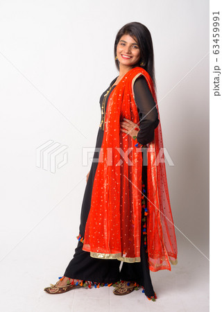 Full body shot of happy young Persian woman smiling in traditional clothing Full body shot of happy young Persian woman smiling in traditional clothing 63459991