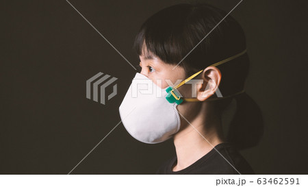 Asian woman wearing n95 healthy mask for protect coronavirus or covid-19 and pm 2.5 dangerous dust from bad air pollution which shoot in studio with clear black color background. 63462591
