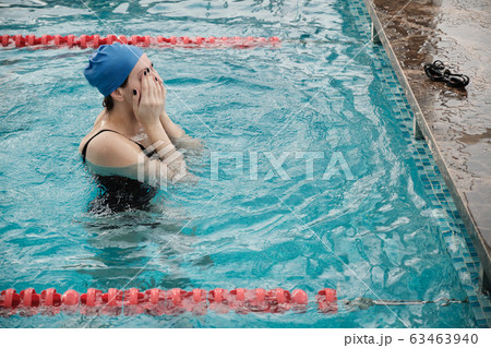 Rubbing eyes in swimming pool Rubbing eyes in swimming pool 63463940