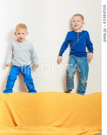 Two little boys siblings playing together Two little boys siblings playing together 63464506