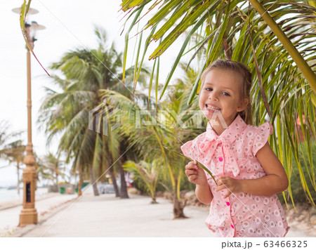 beautiful baby girl in the pink shirt is staying 63466325