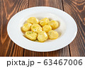 Plate of boiled potatos on wooden table 63467006