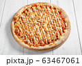 Fresh italian pizza with chicken on wooden table 63467061