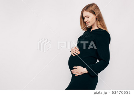 Pregnant happy woman in black dress. Fashion shot 63470653