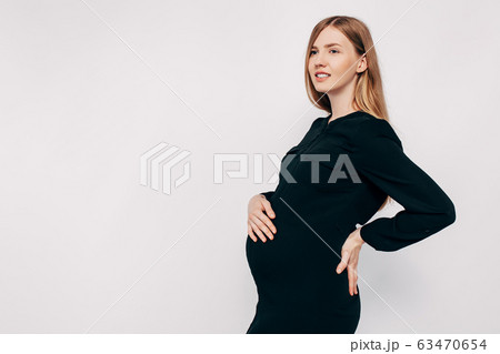 Pregnant happy woman in black dress. Fashion shot Pregnant happy woman in black dress. Fashion shot 63470654