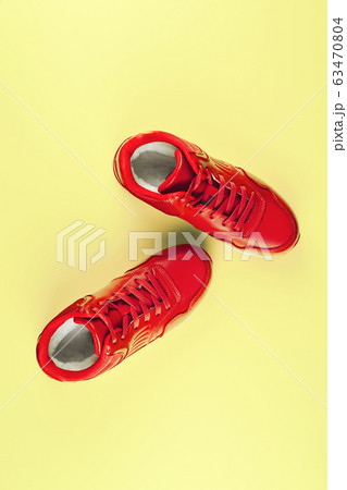 Red sneakers on pastel yellow background. Concept of sport and healthy lifestyle 63470804