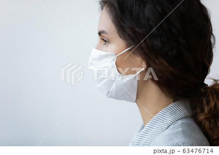 Profile view face of woman in protective medical mask Profile view face of woman in protective medical mask 63476714