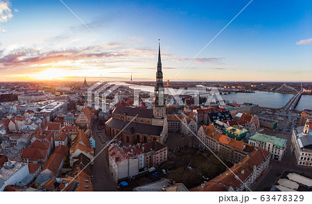 Aerial panoramic view to histirical center Riga, quay of river Daugava. Famous Landmark - st. Peter's Church's tower and City Dome Cathedral church, Old Town Monument. Latvia, Europe. shot from drone Aerial panoramic view to histirical center Riga, quay of river Daugava. Famous Landmark - st. Peter's Church's tower and City Dome Cathedral church, Old Town Monument. Latvia, Europe. shot from drone 63478329