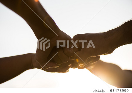 Close up bottom view of people giving fist bump Close up bottom view of people giving fist bump 63478990